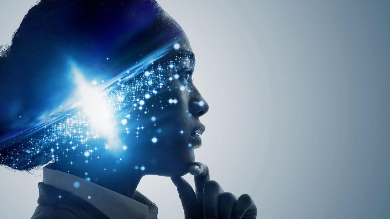 A woman's face in profile. She looks like she is thinking. There is an image of a universe superimposed on the side of her head.