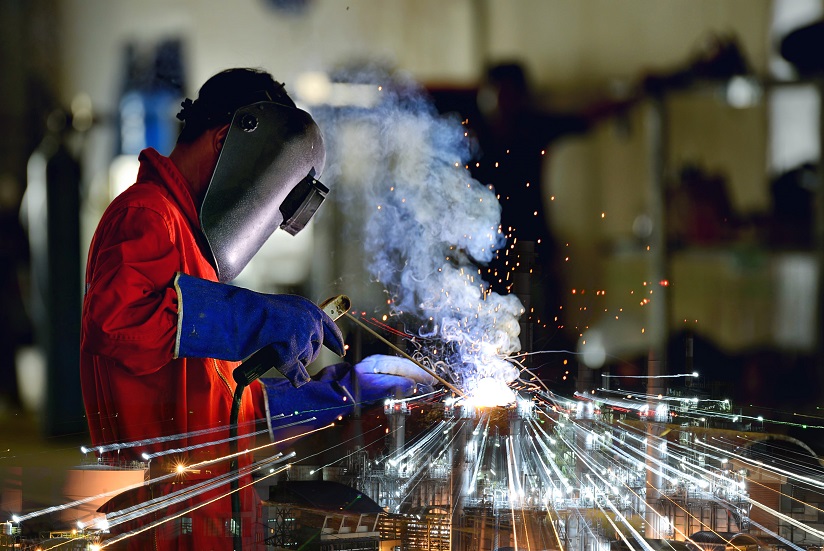 An image of a metalworker welding.